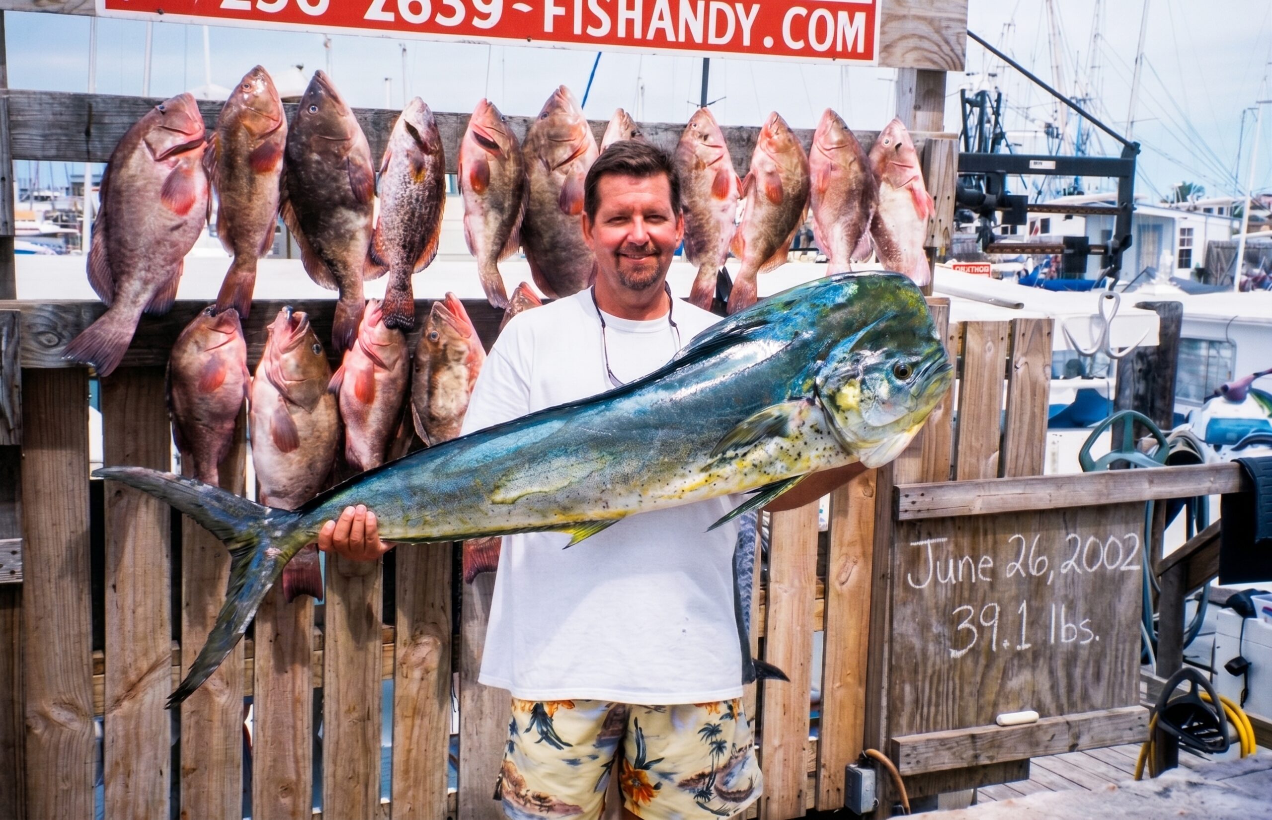 Jim holding a mahi-mahi after a Fish Andy charter out of Stock Island, Florida, June 26, 2002.